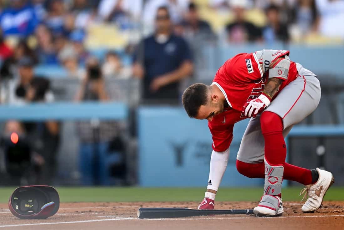 baseball player picking up the bat