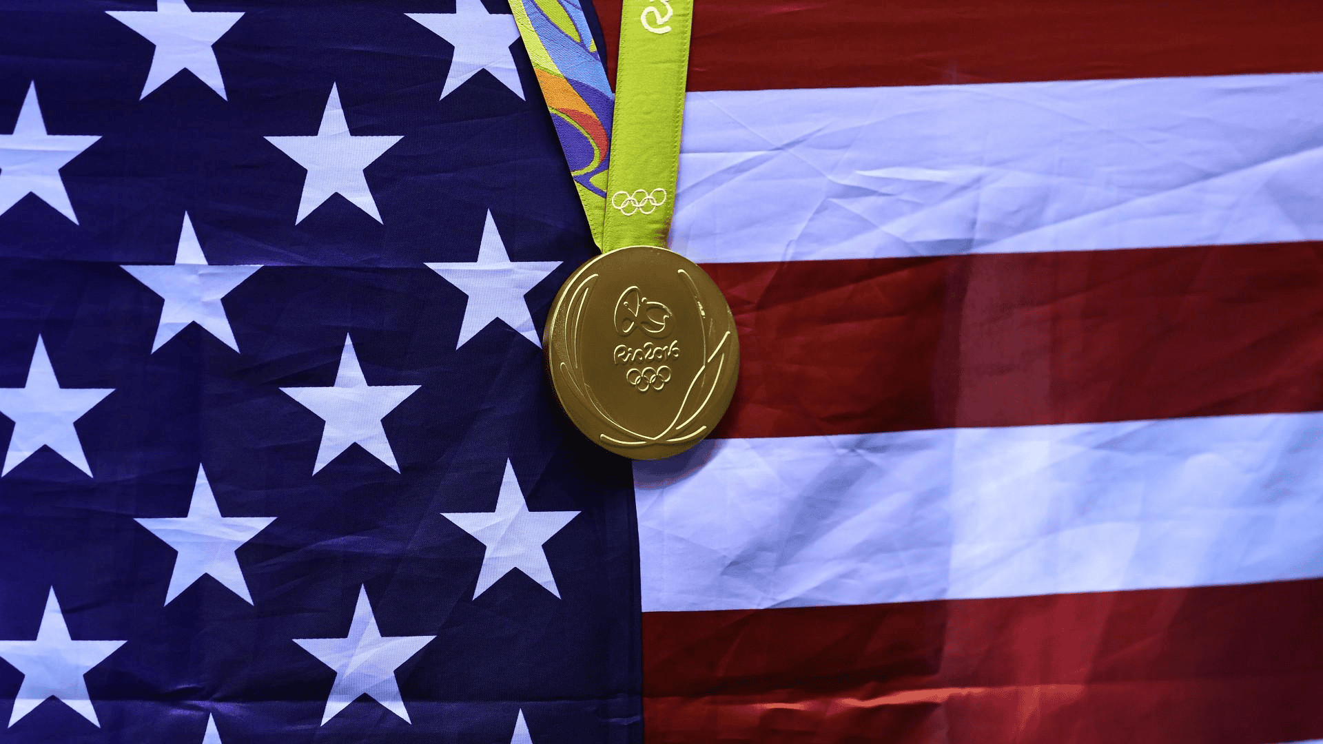 Usa gold medals won in front of flag