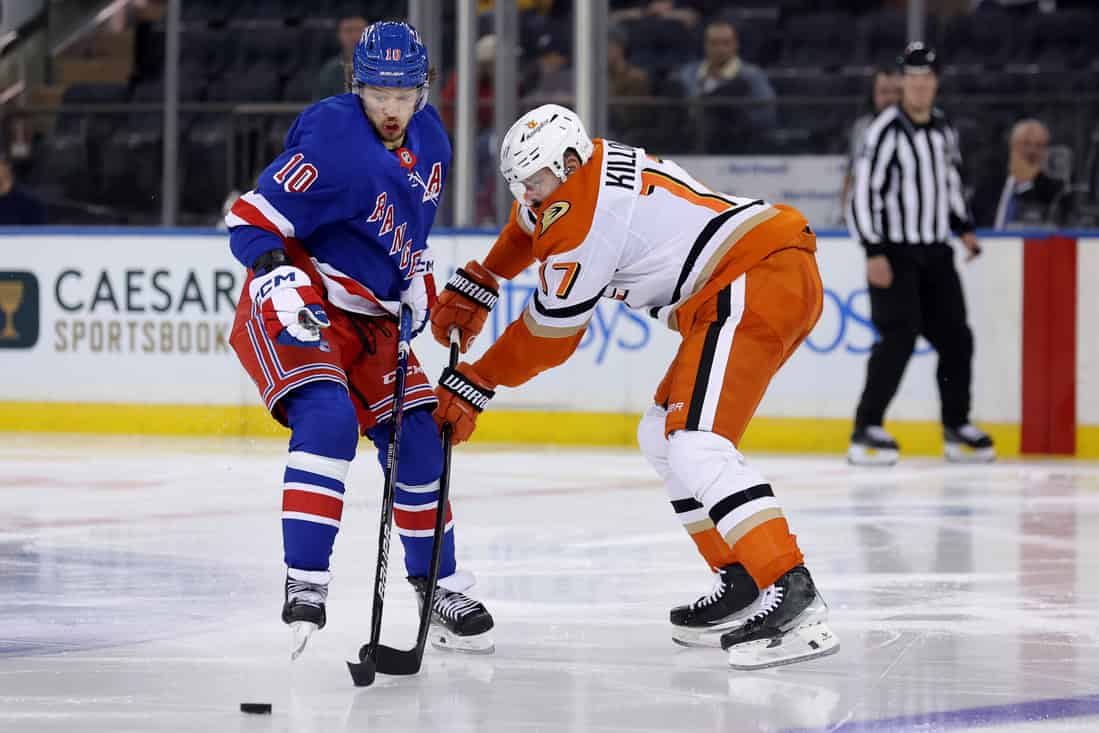 Rangers Player Contesting the Puck