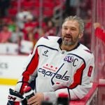 Capital Player leaning on the glass