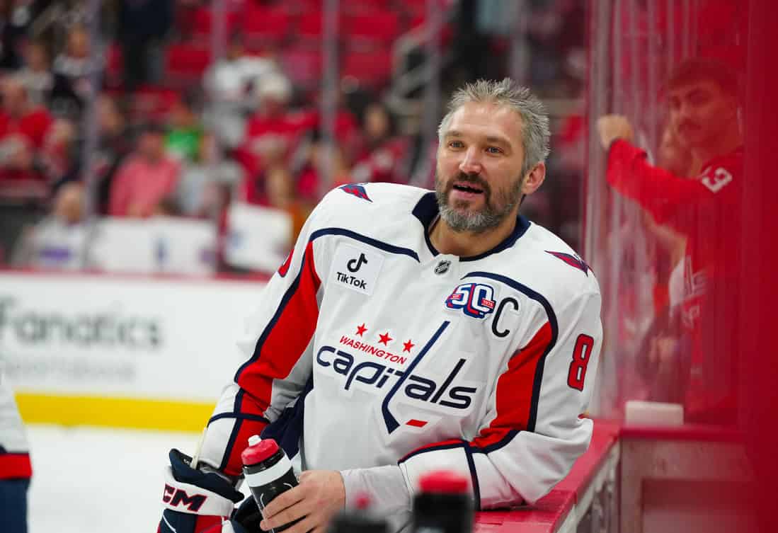 Capital Player leaning on the glass